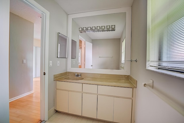 bathroom featuring tile flooring and vanity