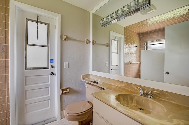 bathroom featuring vanity, tile floors, and toilet