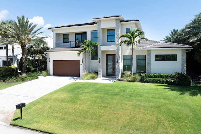 view of front of house with a front lawn and a garage