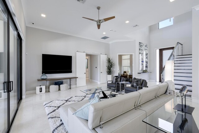 living room featuring crown molding, ceiling fan, and light tile floors