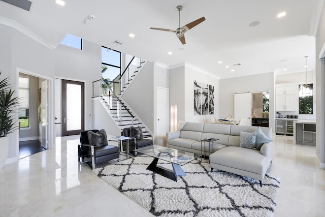 living room with ceiling fan, crown molding, and light tile flooring