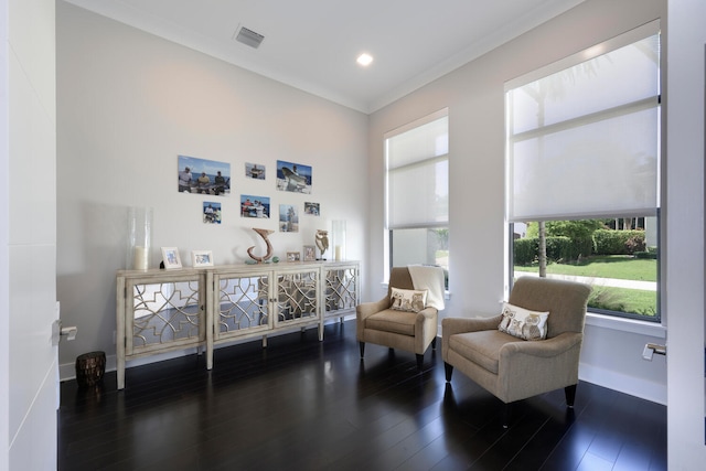 sitting room with dark hardwood / wood-style floors and crown molding