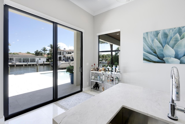 interior space featuring tile floors and a water view