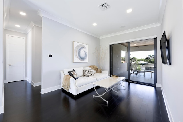 living room with dark hardwood / wood-style floors and crown molding