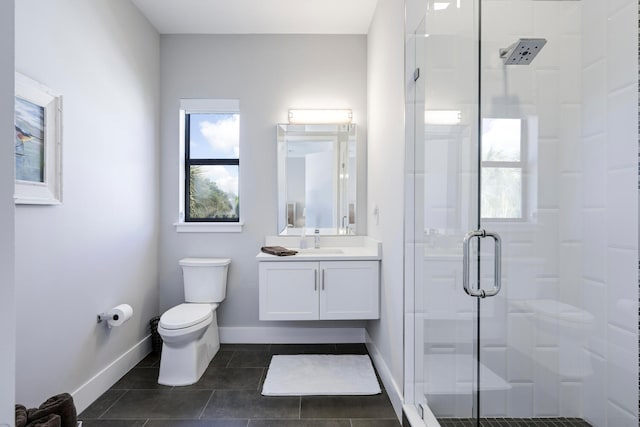 bathroom featuring tile floors, a shower with shower door, toilet, and vanity