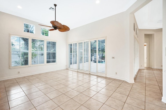 tiled empty room with ceiling fan