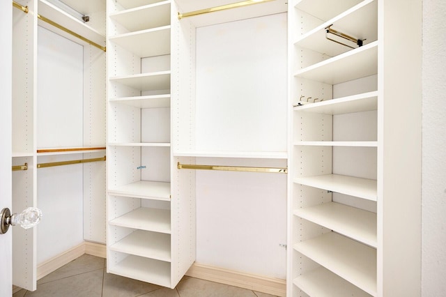 spacious closet with light tile floors