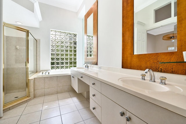 bathroom featuring dual sinks, shower with separate bathtub, tile flooring, vanity with extensive cabinet space, and ornamental molding