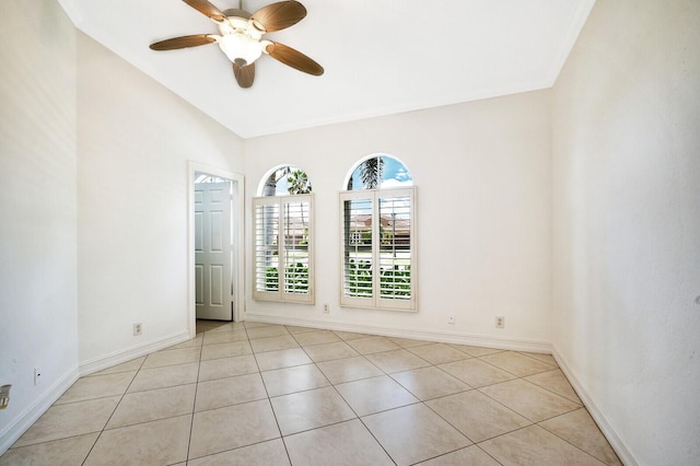 tiled spare room with ceiling fan and vaulted ceiling