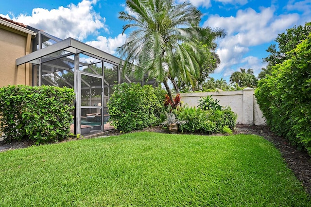 view of yard featuring glass enclosure