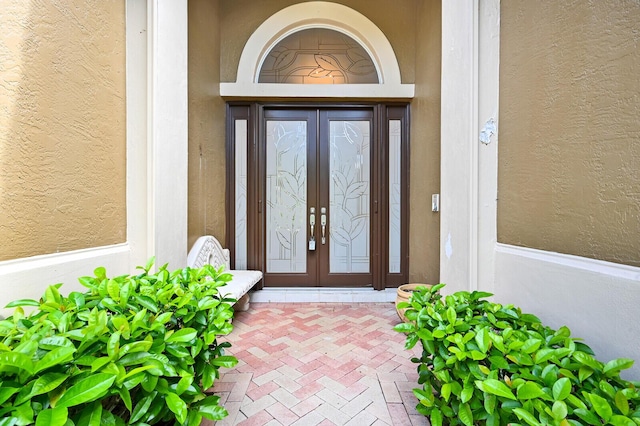 view of exterior entry featuring french doors