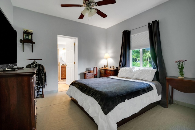 carpeted bedroom with ceiling fan and ensuite bathroom