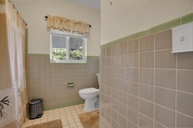 bathroom with tile walls, toilet, and tile floors