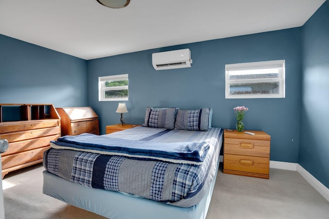 bedroom with light carpet and an AC wall unit