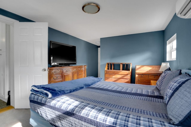 carpeted bedroom featuring a wall mounted air conditioner