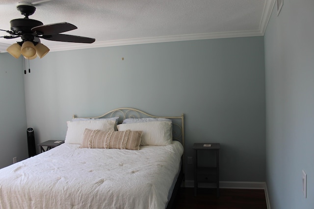 bedroom with ornamental molding, ceiling fan, a textured ceiling, and dark hardwood / wood-style flooring