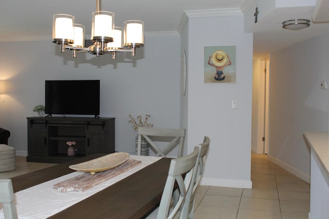 tiled dining room featuring crown molding and a chandelier