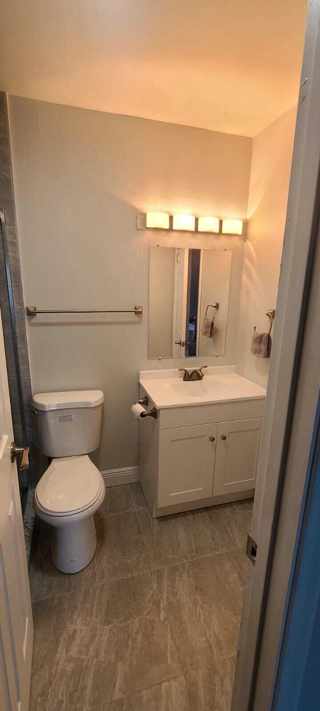 bathroom with vanity, tile flooring, and toilet