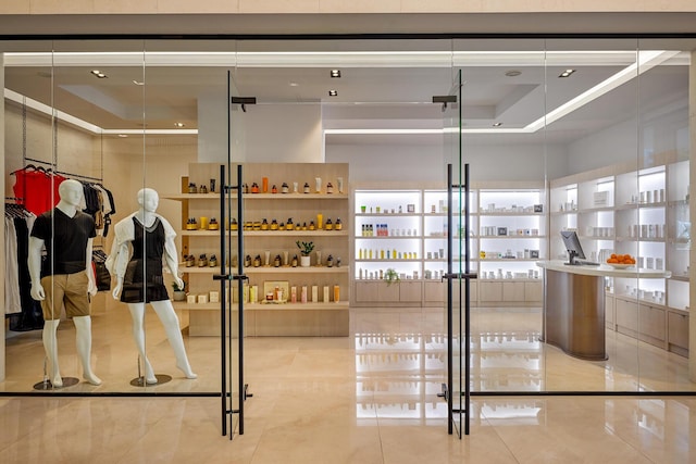 interior space featuring a raised ceiling and tile patterned flooring