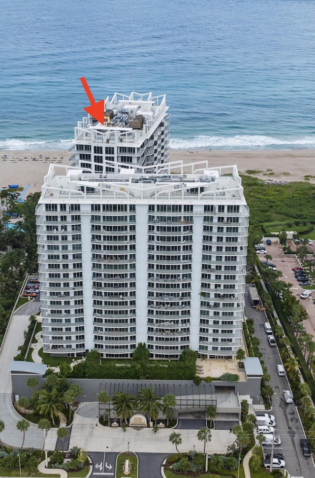 drone / aerial view featuring a water view and a beach view