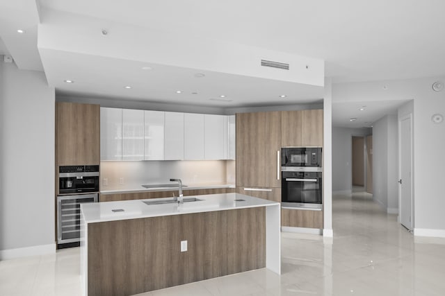 3100 N Ocean Dr Unit H-1509, Singer Island, FL 33404 - kitchen with black appliances, modern cabinets, beverage cooler, a sink, and recessed lighting