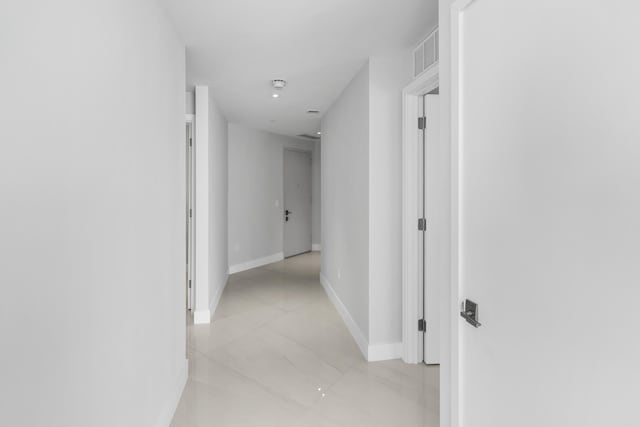 corridor with light tile patterned flooring