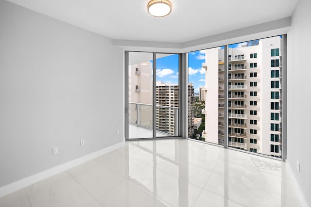 3100 N Ocean Dr Unit H-1509, Singer Island, FL 33404 - tiled spare room featuring a view of city and baseboards