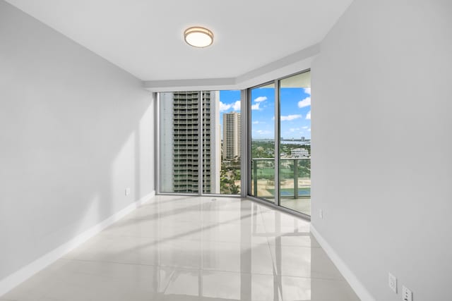 tiled empty room with floor to ceiling windows