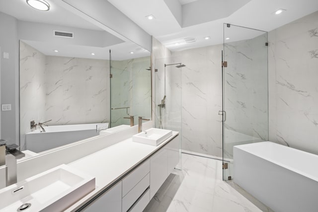 3100 N Ocean Dr Unit H-1509, Singer Island, FL 33404 - bathroom featuring marble tiled flooring, a freestanding tub, double vanity, a marble finish shower, and recessed lighting