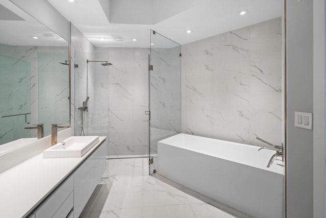 bathroom featuring vanity, tile walls, and shower with separate bathtub