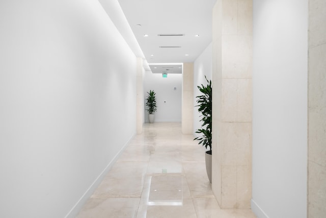 hall with light tile patterned floors