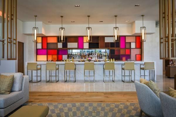 bar featuring hardwood / wood-style floors and decorative light fixtures