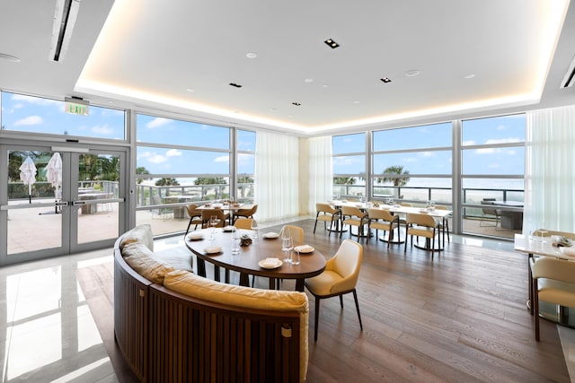 3100 N Ocean Dr Unit H-1509, Singer Island, FL 33404 - dining room with floor to ceiling windows, a tray ceiling, french doors, light wood finished floors, and recessed lighting