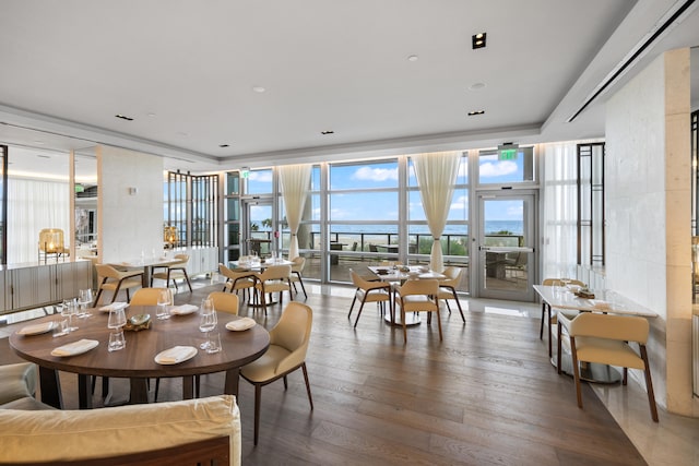 dining space featuring hardwood / wood-style floors and expansive windows