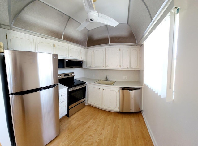 kitchen featuring white cabinets, light hardwood / wood-style floors, stainless steel appliances, and sink