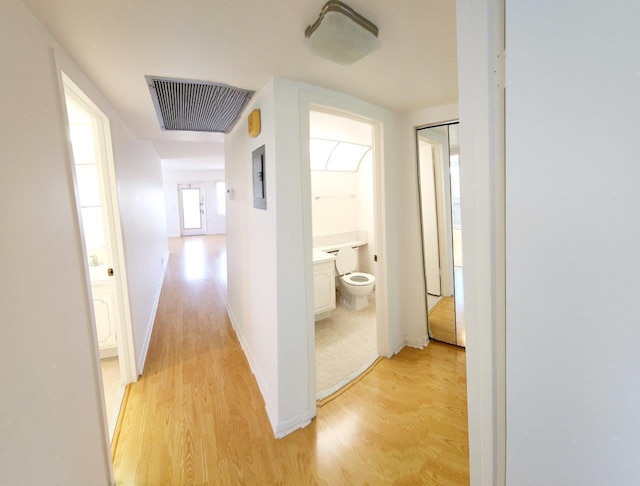 corridor with light hardwood / wood-style floors