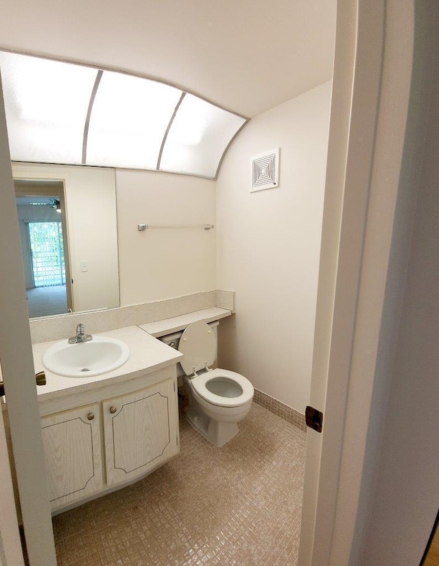 bathroom with vanity, tile flooring, and toilet