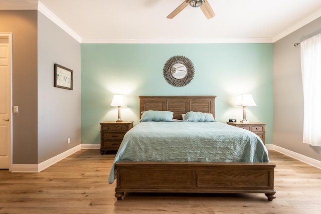 bedroom featuring crown molding, light hardwood / wood-style floors, and ceiling fan