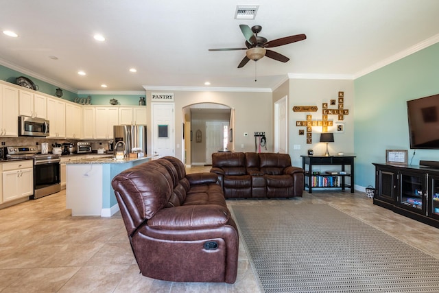 living room with ornamental molding, ceiling fan, and light tile floors