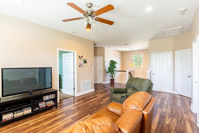 living room featuring ceiling fan and dark hardwood / wood-style floors