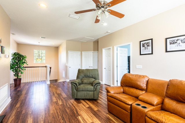 living room featuring ceiling fan and dark hardwood / wood-style flooring