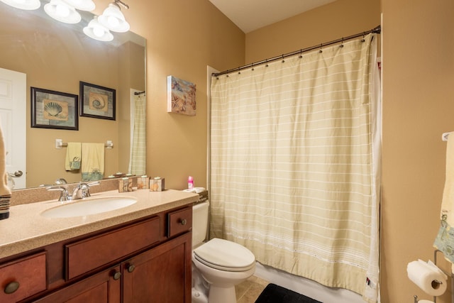 bathroom featuring toilet, large vanity, and tile floors