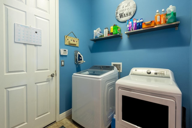 washroom with hookup for a washing machine, washer and clothes dryer, and tile floors