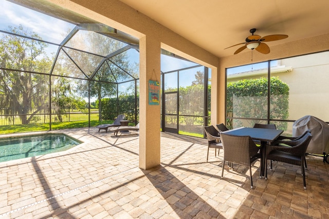 sunroom / solarium featuring ceiling fan