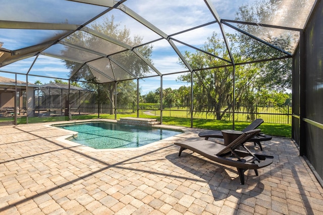 view of pool featuring a lawn, a patio, and a lanai