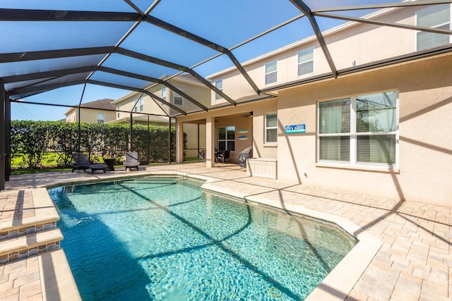 view of pool featuring a lanai and a patio area