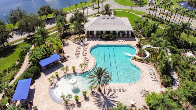 view of swimming pool with pool water feature and a patio area