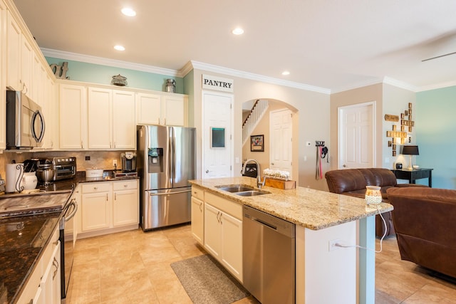 kitchen featuring an island with sink, sink, light tile floors, crown molding, and stainless steel appliances