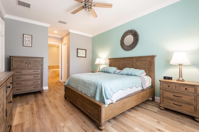 bedroom with ceiling fan, connected bathroom, light hardwood / wood-style flooring, and crown molding