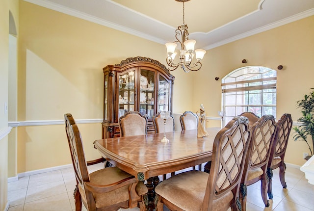 dining space featuring light tile floors, a raised ceiling, a notable chandelier, and crown molding